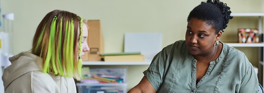 a young person and adult talking